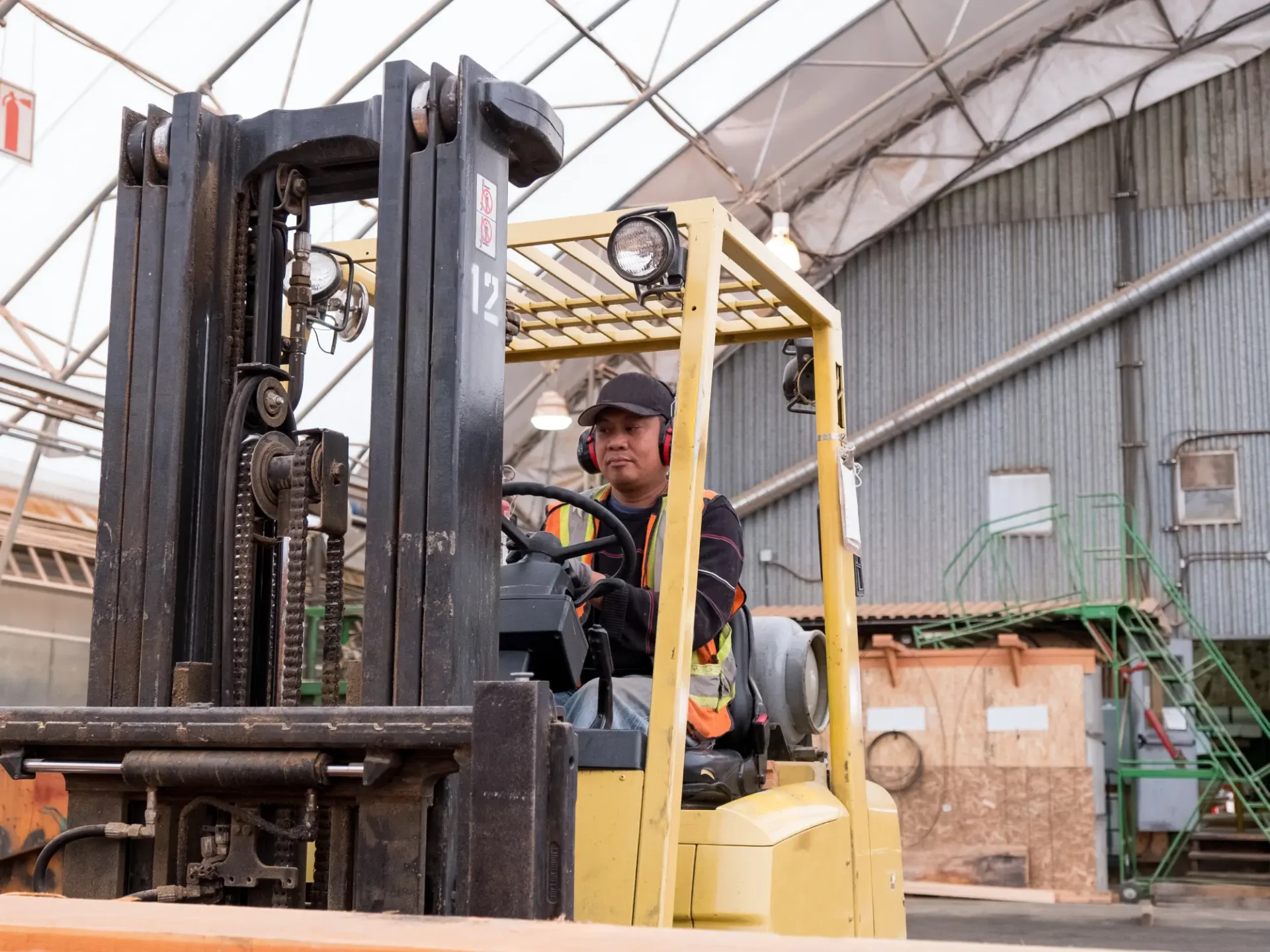 Worker driving a forklift indoors