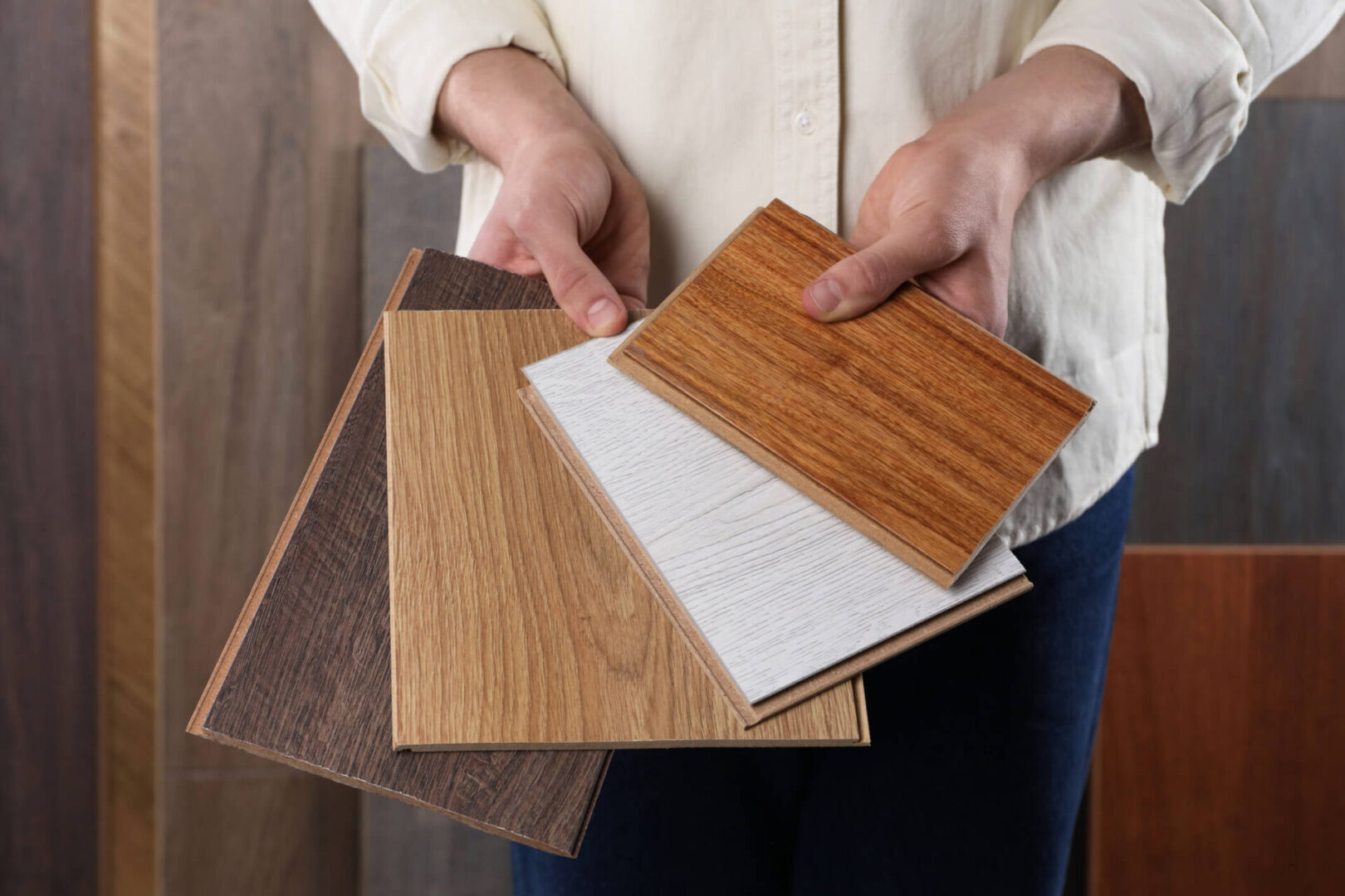 Hands displaying different wooden panel options
