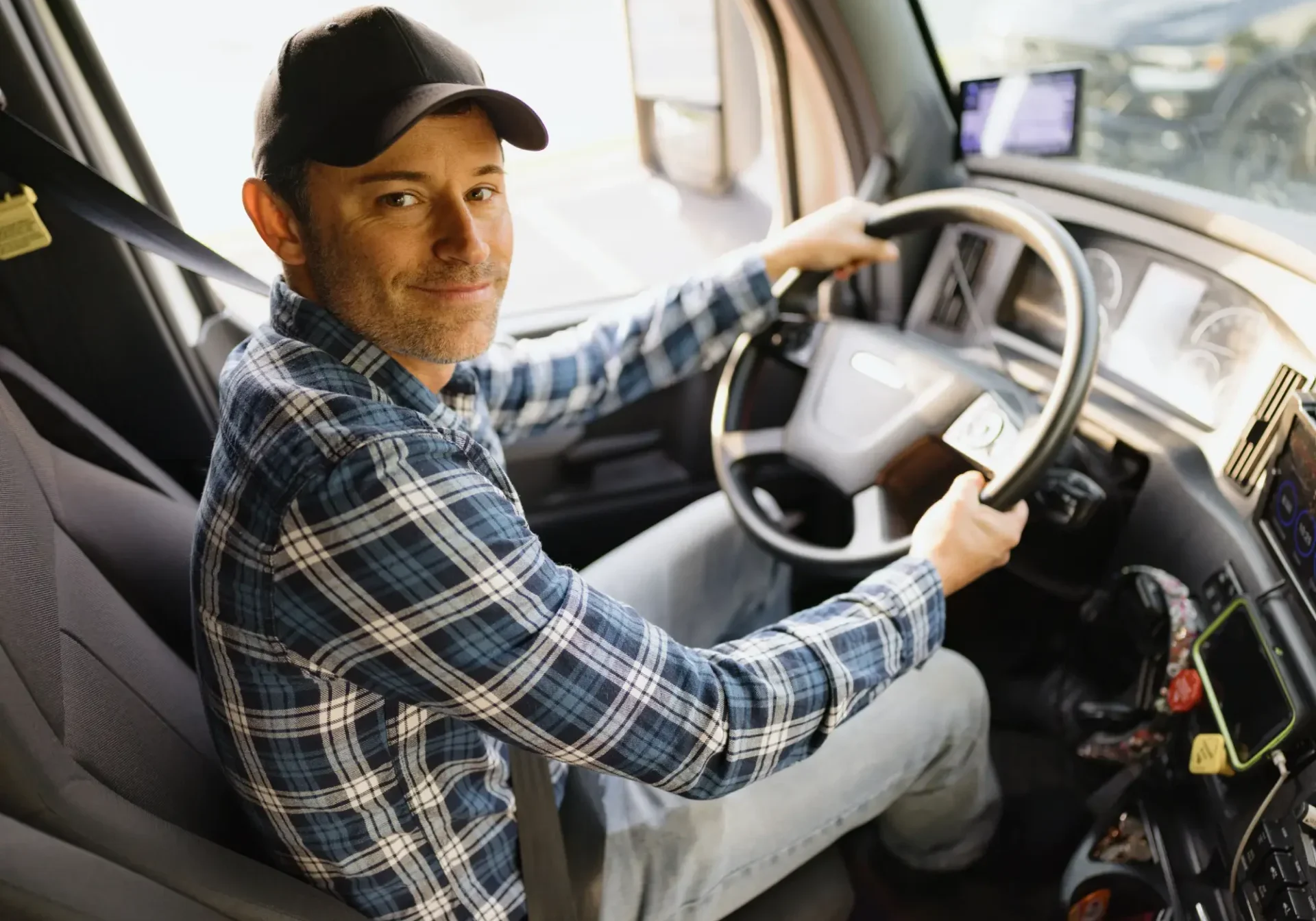 Happy driver inside a truck cab