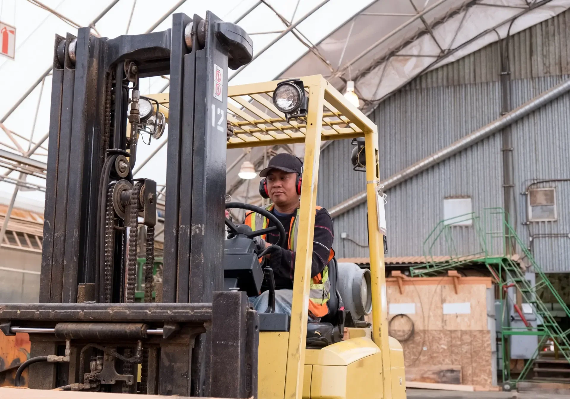 Worker driving a forklift indoors