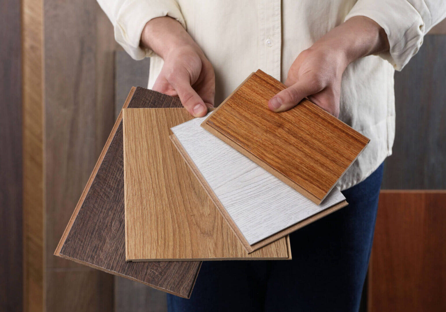 Hands displaying different wooden panel options